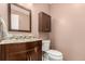 Bathroom with stylish vanity, mirror, sink, and toilet at 2014 S Pagosa St, Aurora, CO 80013