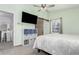 Bedroom features a ceiling fan, carpet, and a sliding barn door at 2014 S Pagosa St, Aurora, CO 80013