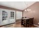 Dining area with wood floors, stylish chandelier, and access to the back deck at 2014 S Pagosa St, Aurora, CO 80013