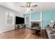 Living room features hardwood floors, fireplace, and a ceiling fan at 2014 S Pagosa St, Aurora, CO 80013