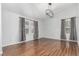 Spacious living room with hardwood floors, lots of natural light, and modern lighting at 2014 S Pagosa St, Aurora, CO 80013