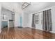 Bright living room with hardwood floors, modern lighting, and a staircase at 2014 S Pagosa St, Aurora, CO 80013