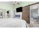 This main bedroom features a sliding barn door to the bathroom and large closets at 2014 S Pagosa St, Aurora, CO 80013