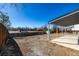View of a backyard with a covered patio, a wooden fence, and parking visible in the distance at 4752 E 108Th Pl, Thornton, CO 80233