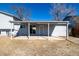 Spacious backyard featuring a covered patio area, against a brilliant blue sky at 4752 E 108Th Pl, Thornton, CO 80233