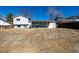 View of a large backyard featuring a patio and the home's rear exterior against a clear blue sky at 4752 E 108Th Pl, Thornton, CO 80233