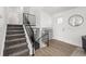 Bright entryway with staircase, wood floors, and a modern white front door at 4752 E 108Th Pl, Thornton, CO 80233