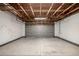 Spacious garage with an open ceiling and a large, modern gray door at 4752 E 108Th Pl, Thornton, CO 80233