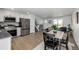 Open-concept kitchen with stainless appliances, dining area, and living room at 4752 E 108Th Pl, Thornton, CO 80233