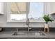 Close up of kitchen sink and faucet with quartz countertop and plants by the window at 4752 E 108Th Pl, Thornton, CO 80233
