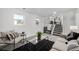 Living room featuring two large windows, gray carpet and a modern sofa and chairs at 4752 E 108Th Pl, Thornton, CO 80233