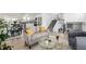 Open-concept living room with adjoining kitchen, dining area, and staircase at 4752 E 108Th Pl, Thornton, CO 80233