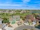 Aerial view of a green home with a well-kept lawn near a scenic lake and golf course at 483 S Kingston Cir, Aurora, CO 80012