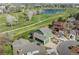 An aerial view of a two-story green home, backing up to a green area with a pond at 483 S Kingston Cir, Aurora, CO 80012