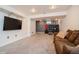 A finished basement with carpet, a flat-screen television, and space for exercise equipment at 483 S Kingston Cir, Aurora, CO 80012