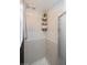 Tile shower featuring gray tiles, shower head, and mounted storage caddy at 483 S Kingston Cir, Aurora, CO 80012