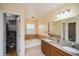 Bathroom featuring double vanity, tub and shower combo, and walk-in closet at 483 S Kingston Cir, Aurora, CO 80012