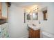 Bathroom with wood vanity, bright lighting, mirror, and towel rack at 483 S Kingston Cir, Aurora, CO 80012