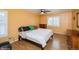 Bedroom with white and yellow walls, wood dresser, bed and ceiling fan at 483 S Kingston Cir, Aurora, CO 80012