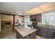 Open kitchen includes stainless appliances, an island with granite countertops, and hardwood floors at 483 S Kingston Cir, Aurora, CO 80012