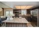 Modern kitchen boasts stainless appliances, wood cabinetry, granite countertops, and an eat-in island at 483 S Kingston Cir, Aurora, CO 80012