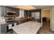 Kitchen with wood cabinets, stainless appliances, granite countertops, and eat-in kitchen island at 483 S Kingston Cir, Aurora, CO 80012