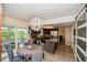Eat-in kitchen features modern chandelier, stainless appliances, kitchen island, and sliding glass doors at 483 S Kingston Cir, Aurora, CO 80012
