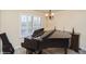 A living room with hardwood floors, neutral walls, and a grand piano at 483 S Kingston Cir, Aurora, CO 80012