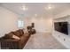 Cozy living room features plush brown sofa, chair, and mounted flat screen television at 483 S Kingston Cir, Aurora, CO 80012