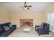 Living room with fireplace, wood floors, two sofas, an arm chair, and natural light at 483 S Kingston Cir, Aurora, CO 80012