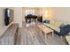 A living room with hardwood floors, neutral walls, a grand piano, and a sofa at 483 S Kingston Cir, Aurora, CO 80012