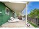 Covered patio offering lounge chairs for relaxing and scenic backyard views at 483 S Kingston Cir, Aurora, CO 80012