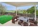 A covered patio with a dining table, outdoor seating, and an open view at 483 S Kingston Cir, Aurora, CO 80012