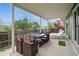 A covered patio with a dining table, outdoor seating, and an open view at 483 S Kingston Cir, Aurora, CO 80012