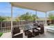 Covered patio with outdoor dining furniture and relaxing backyard views at 483 S Kingston Cir, Aurora, CO 80012