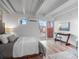 Bright bedroom with a comfortable bed, modern decor, and access to an outdoor patio at 1495 Vrain St # 214, Denver, CO 80204