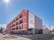 Modern multi-story apartment building with a striking facade, balconies, and well-maintained landscaping at 1495 Vrain St # 214, Denver, CO 80204