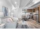 Bright open living space with modern furnishings seamlessly integrates with a stylish kitchen and dining area at 1495 Vrain St # 214, Denver, CO 80204