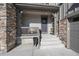 Inviting front porch with stone and wood accents at 7125 S Yantley Way, Aurora, CO 80016