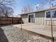 Backyard features a spacious deck, rock ground cover and a partial fence with view of the house at 2850 Lowell Blvd, Denver, CO 80211