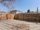 Fenced backyard with wooden deck, stone area, and string lights for outdoor entertaining at 2850 Lowell Blvd, Denver, CO 80211