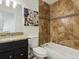 Bathroom features tile surround on the tub, granite countertop on the vanity, and ceramic tile flooring at 2850 Lowell Blvd, Denver, CO 80211