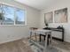 Home office or flex space with a modern desk, neutral walls, and natural light from the window at 2850 Lowell Blvd, Denver, CO 80211