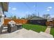 Cozy backyard with manicured lawn, modern patio set, privacy fence, and string lights at 4504 N Clay St, Denver, CO 80211