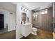 Modern bathroom features sleek vanity, oval mirror, and glass-enclosed shower with brown tile at 4504 N Clay St, Denver, CO 80211