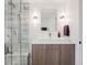 Bathroom featuring a glass enclosed shower and modern vanity with white countertop and wood cabinets at 4504 N Clay St, Denver, CO 80211