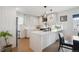 Modern kitchen with an island featuring granite countertops, stainless steel appliances, and natural light at 4504 N Clay St, Denver, CO 80211