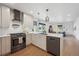 Open concept kitchen with stainless steel appliances, granite countertops and seamless access to the living area at 4504 N Clay St, Denver, CO 80211