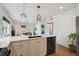 Bright, open kitchen featuring stone countertops, modern appliances and stylish pendant lighting at 4504 N Clay St, Denver, CO 80211