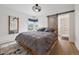 Comfortable main bedroom with wood floors, barn door entry to ensuite bath and large picture window at 4504 N Clay St, Denver, CO 80211
